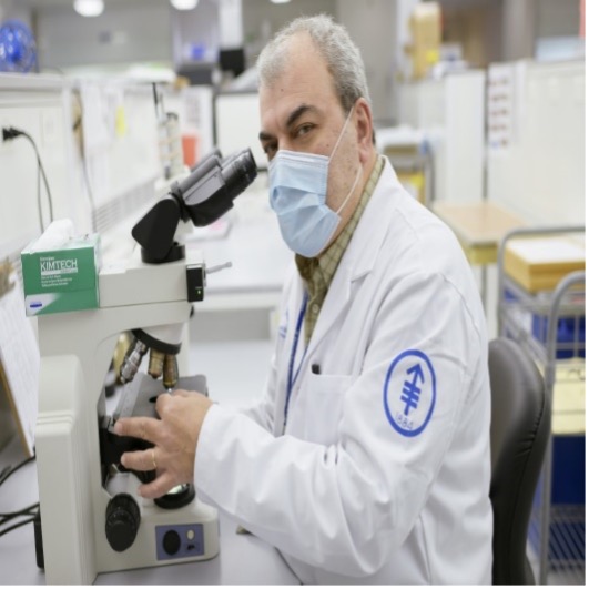 MSK colleague using a microscope