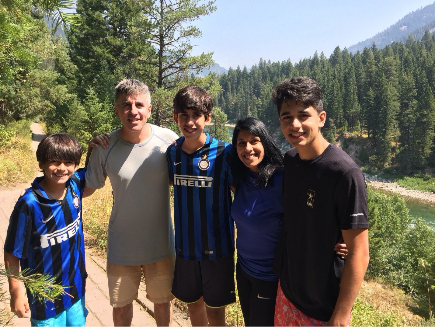 Family photo of Monika, husband and three children out in nature