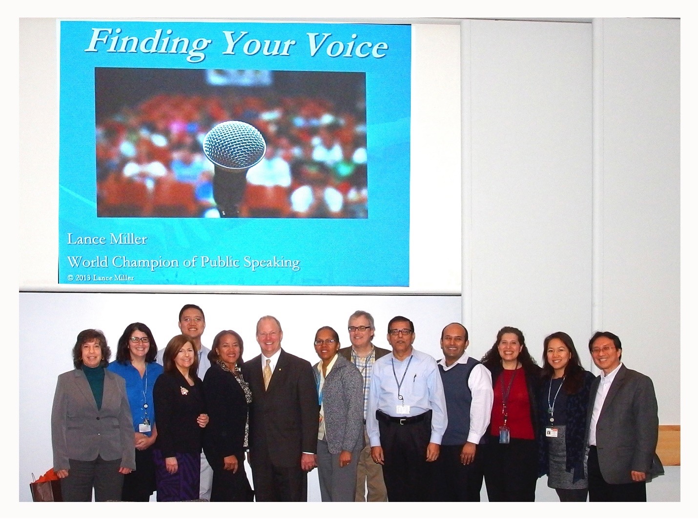 Group of MSK IT Colleagues standing in front of a presentation