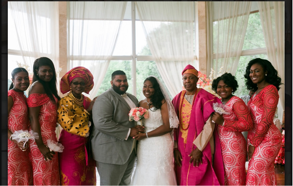 Bride and groom with family members on either side